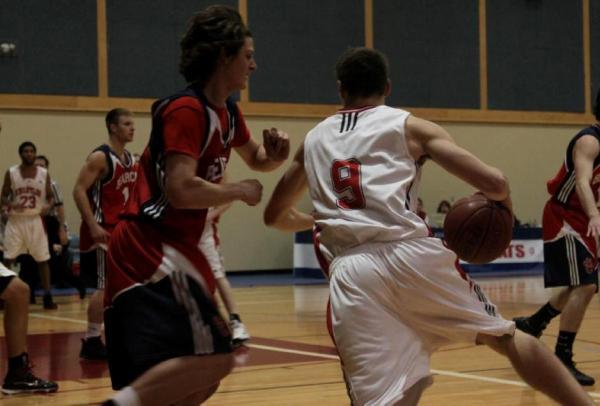 Chris Thompson keeps up the Bearcats defense as Dustin Egelstad moves towards the basket. (Jacob Zinn photo)