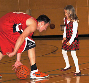 Brenden Graham plays with his niece, six-year-old Samantha, at half time. (Jessica Rolli photo)