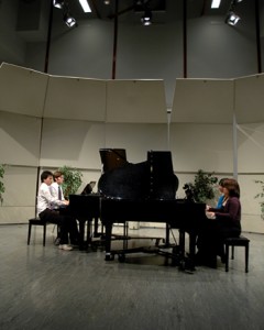 Performing the fifth and final movement of the piece are piano students Ethan Liang and Stuart Martin on the left and Queenie Cheng and May Miyaoka on the right.