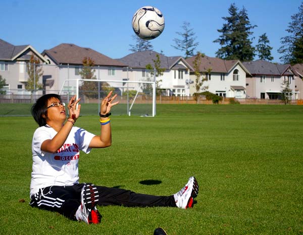 Injured goalkeeper Amelia Ng works on a catching drill at Goldstone Park in Surrey Thursday.