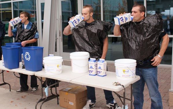 While drinking milk as fast as they could, Mike Kloeble, Jeremy Johnson and Bryan Barker wore garbage bags to keep from spilling on themselves. (Jacob Zinn photo)