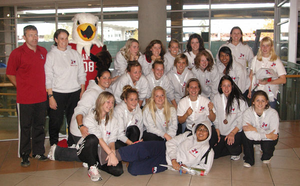 The Kwantlen women's soccer team at YVR with their bronze medals.