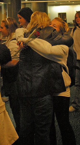 Christina Henderson hugs her mother at YVR after arriving home from the CCAA National tournament in Toronto.