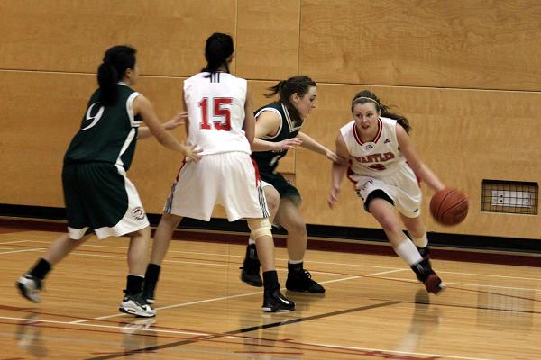 Jessica Williams drives past Jade Arignon towards the basket for two points.