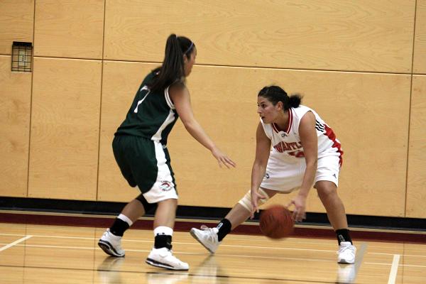 Emily Wright dribbles the ball while attempting to pass Stephanie Scott.
