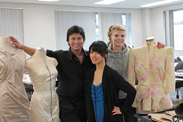 Fashion students pose with some of their work